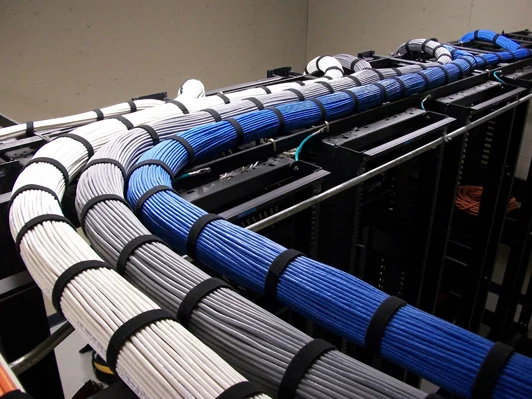 Bundled network cables routed through a server rack